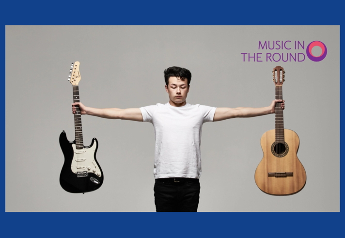 Sean Shibe stands, eyes closed, with both his arms outstretched to his sides, with an electrical guitar in one hand and an acoustic guitar in the other.