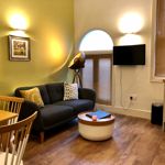 Homely Apartments – Figtree living room with bright interior, stylish furnishings, and inviting atmosphere.