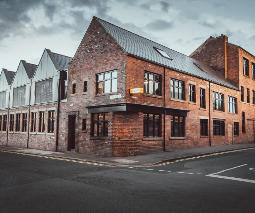 A red brick building in the centre of Sheffield, that is an old industrial building repurposed as offices.