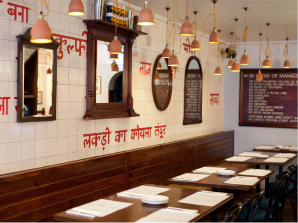 The interior of a restaurant with Indian decor.
