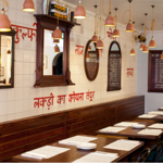 The interior of a restaurant with Indian decor.