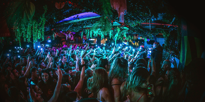 People dancing in a crowded nightclub.