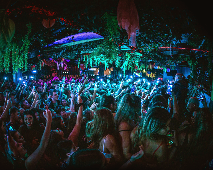 People dancing in a crowded nightclub.