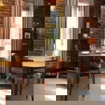 A table and chairs by a window.