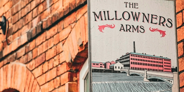 The sign hanging outside The Millowners Arms.