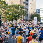 Group of people taking part in Sheffield Half Marathon, running along Arundel Gate.