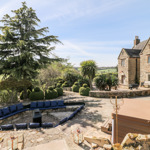 Sykes Holiday Cottage surrounded by rolling hills and open countryside.