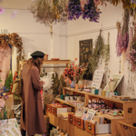 Inside the shop Moonko, on Division Street, a woman is browsing and looking at the displays.
