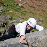 A woman climbing a rock face.
