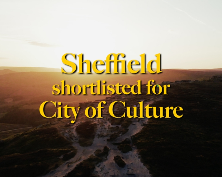 Promotional graphic showing a sunrise or sunset over a rugged moorland and rocky landscape, viewed from above. Large gold text in the centre reads: “Sheffield shortlisted for City of Culture.” The warm orange light illuminates the horizon while the foreground remains in shadow, creating a dramatic backdrop for the announcement.