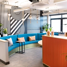 A reception area with chairs and a workstation. 