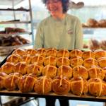 A tray of hot cross buns, fresh out of the oven.