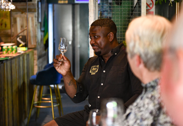 A man enjoying a glass of rum.