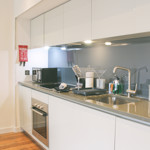 Modern kitchen at Homely Serviced Apartments – St. Paul’s with appliances and storage units.