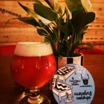 A glass of beer on a table next to a small pot plant at Jabbarwocky.