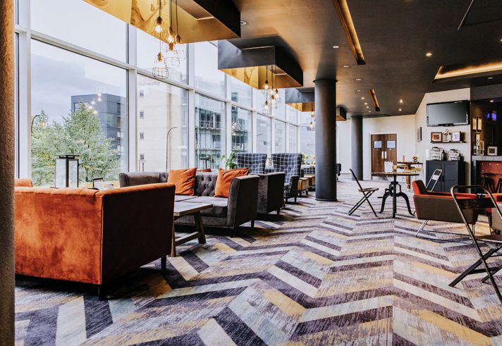 Contemporary bar area with large, comfortable seats and modern decor.