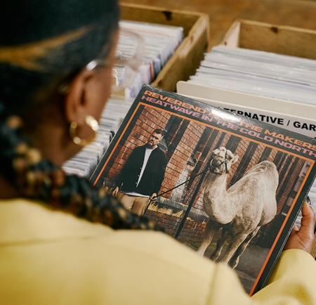 A woman looks at the cover of an album at Bear Tree Records in Sheffield.