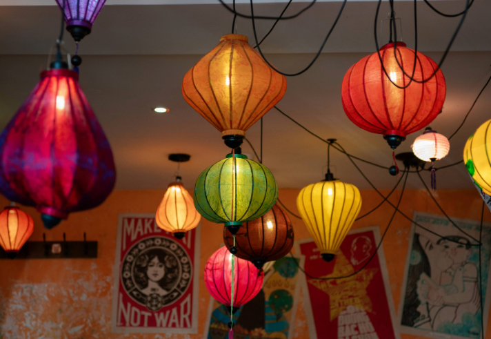 An array of brightly coloured Vietnamese lanterns hang from a ceiling.