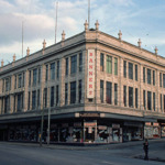 A large stone building in an urban setting.