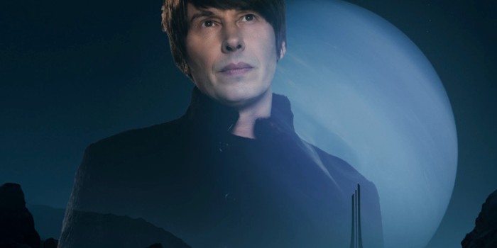 A dark, futuristic landscape with rocky terrain in the foreground and a towering structure in the distance. Behind the structure is a massive planet with a glowing blue hue, dominating the night sky. The scene has a sci-fi aesthetic with dramatic lighting and deep shadows.