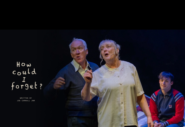 Production image for How Could I Forget featuring a man and woman, both with grey hair, talking animatedly. A younger man wearing a tracksuit jacket sits on a bed behind them.