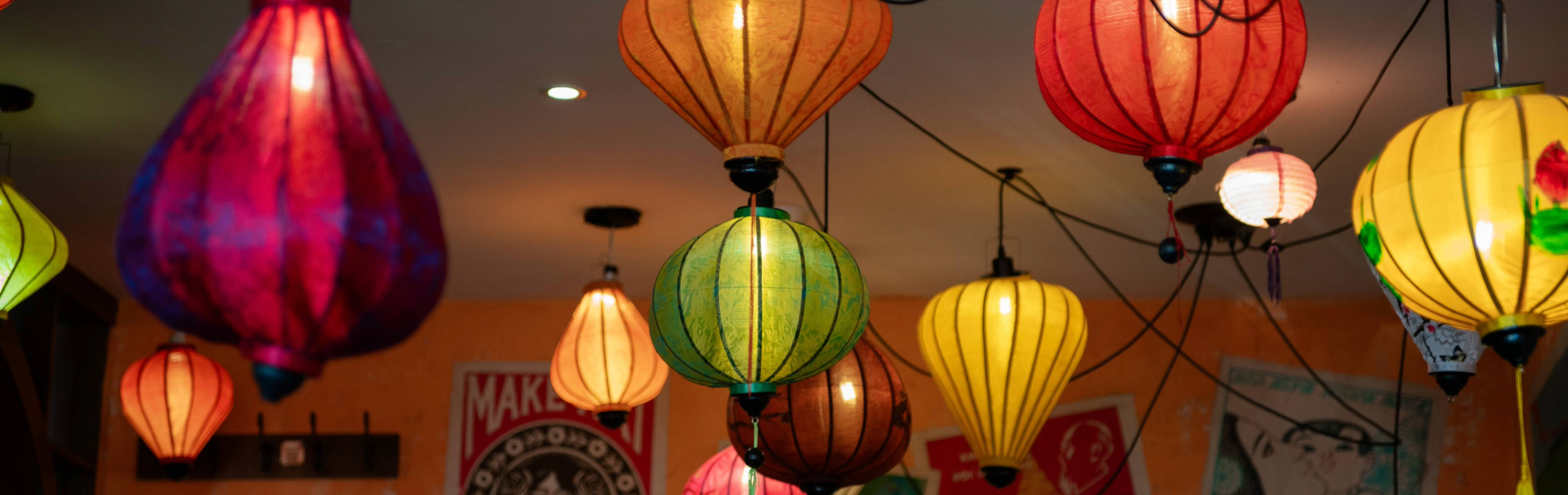 An array of brightly coloured Vietnamese lanterns hang from a ceiling.