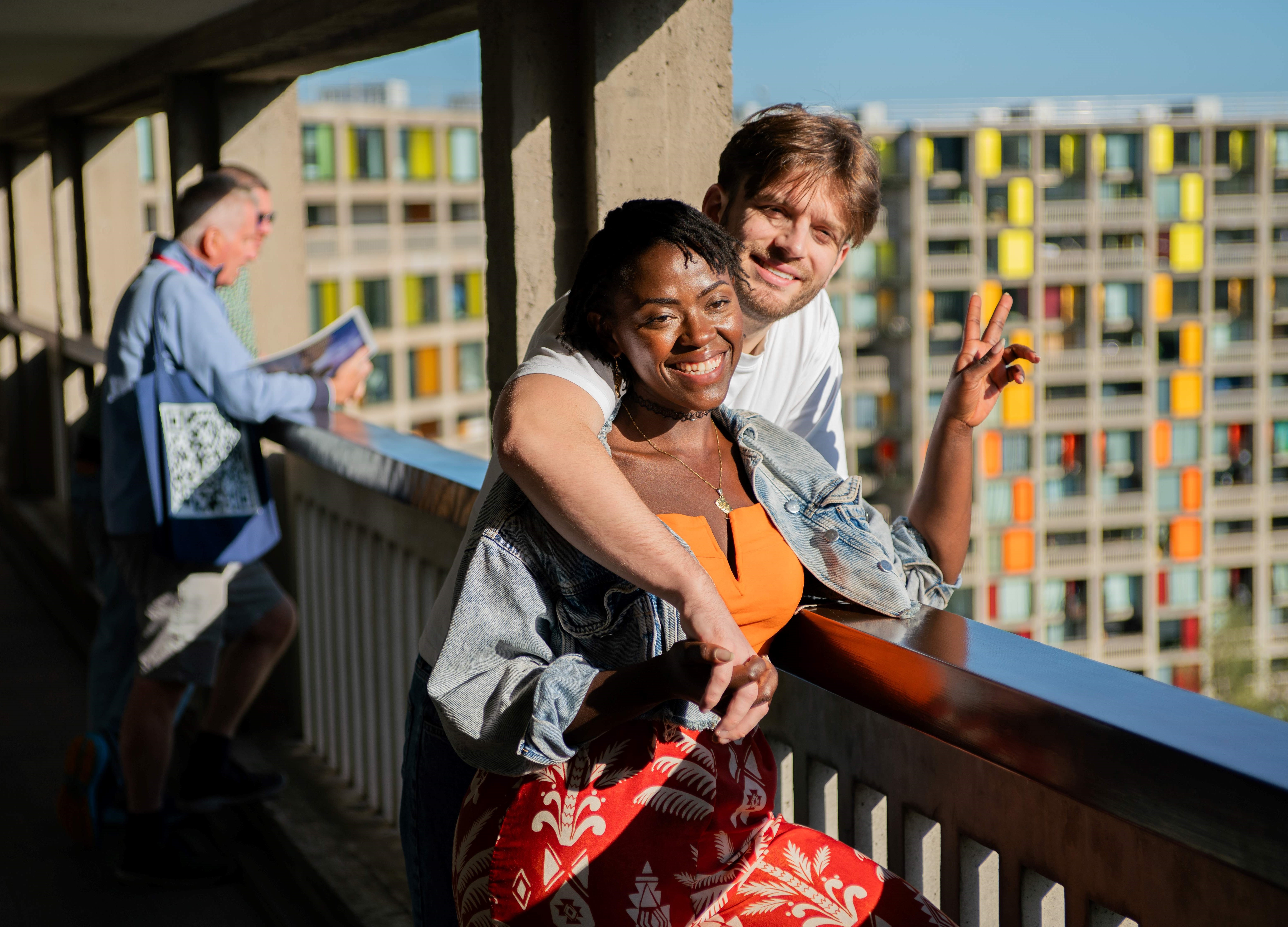 Visitors take part in a guided tour at Park Hill in Sheffield, standing along an elevated walkway with views across the city.