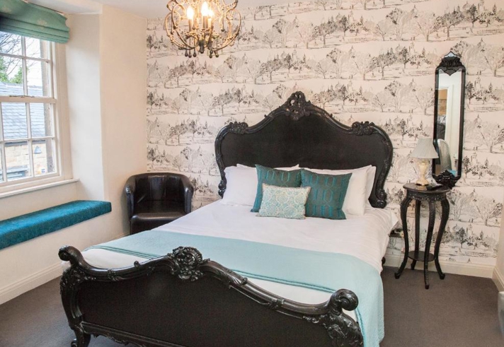 Spacious double bedroom with a large bed, ample floor space, bedside tables