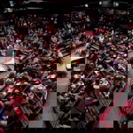A packed house at the Crucible Theatre waits in anticipation for a classical concert to start. In the centre of the stage stands a grand piano.