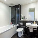 Modern black and white bathroom with sleek fixtures and contrasting tile design.