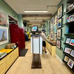 The interior of McKee Gallery, with the walls lines with prints for sale.