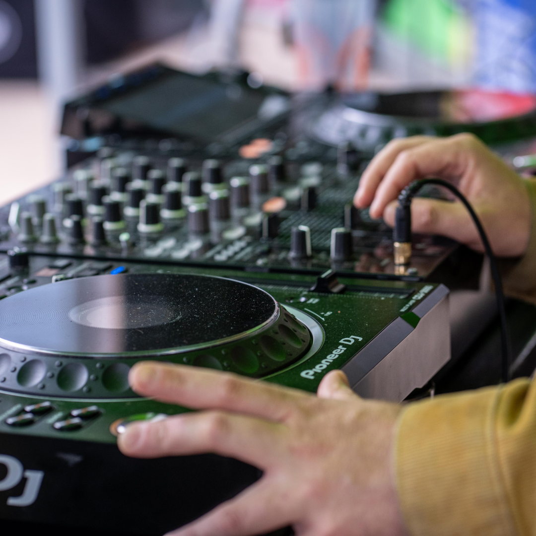 A DJ playing music on decks.