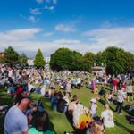 Blue skies over Devonshire Green as groups of people sit in the sunshine watching performances on the Fringe main stage 