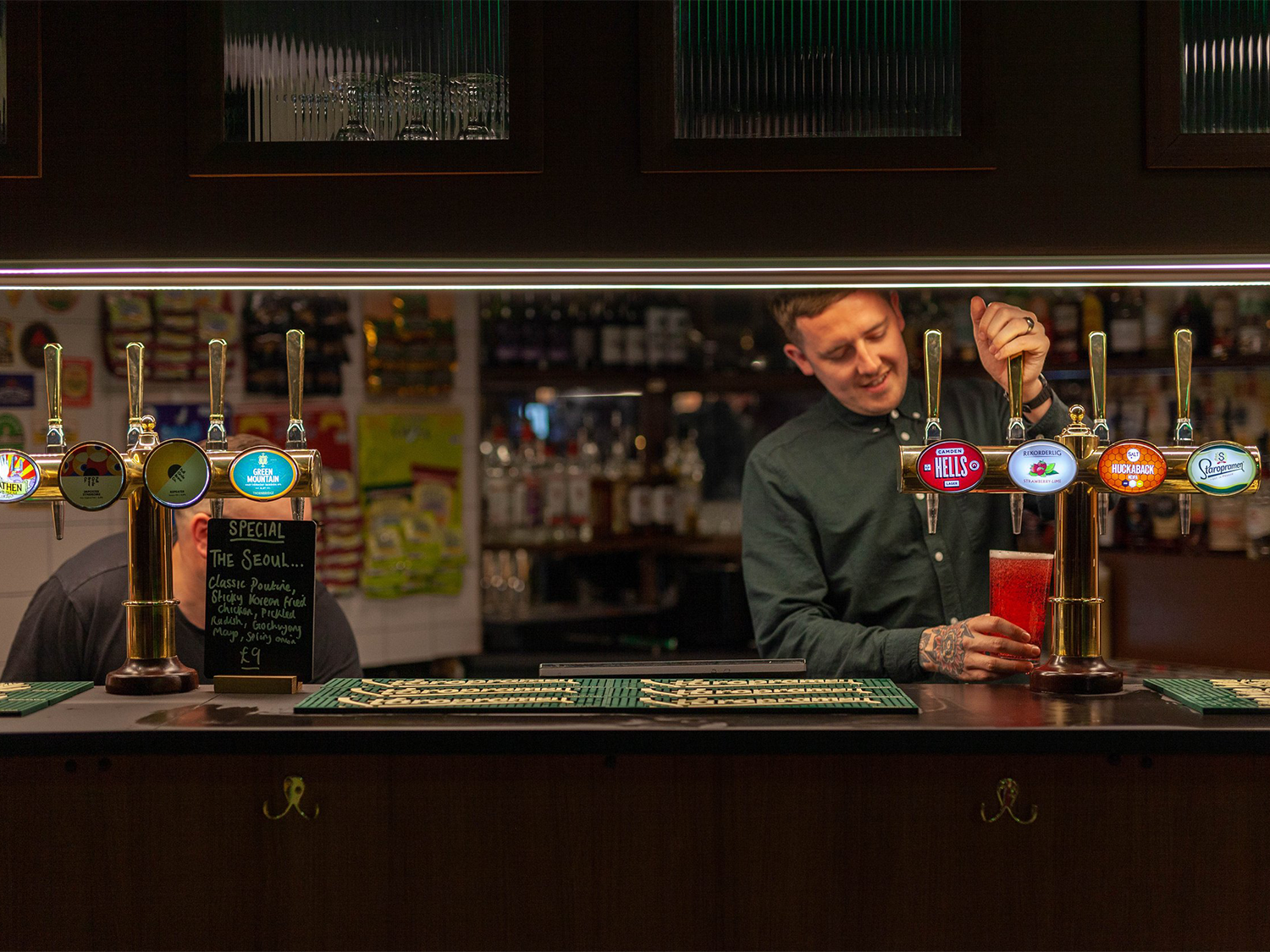 Two members of staff working behind the bar at Neepsend Social Club & Canteen