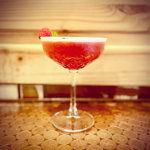 A red cocktail on a table.