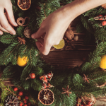 Close up of a person making a Christmas wreath.