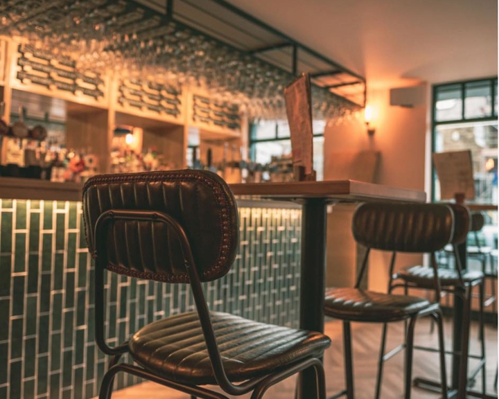 A high table with bar stools at The Dark Horse.