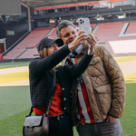 A couple taking a selfie on the pitch at Bramall Lane, on the  Bramall Lane Stadium Tour.