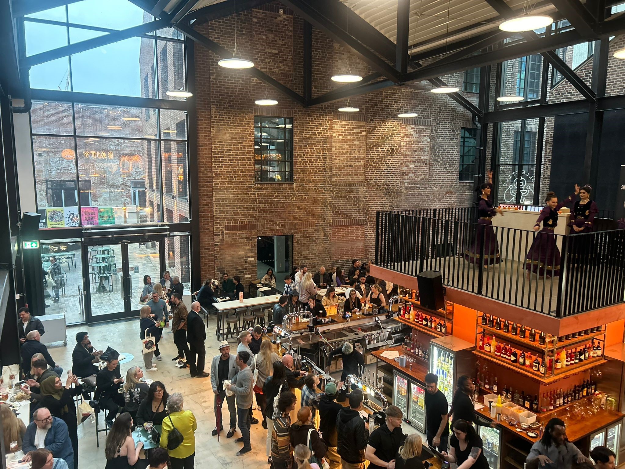 Inside Cambridge Street Collective, filled with people eating and drinking.