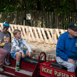 A family rides on a miniature steam train at the Abbeydale Miniature Railway in Sheffield.