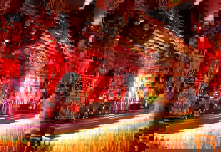 The bar, decorated in a Tiki style, at the Bamboo Door.