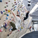 Two people on a climbing wall at Depot Climbing.