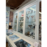 Glass display cases filled with various items for sale at All Good Stuff.