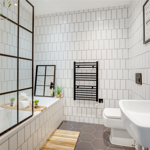 Modern bathroom with full amenities, including a sink, toilet, shower, and contemporary fixtures.