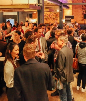 Entrepreneurs mingle at a busy networking event. 
