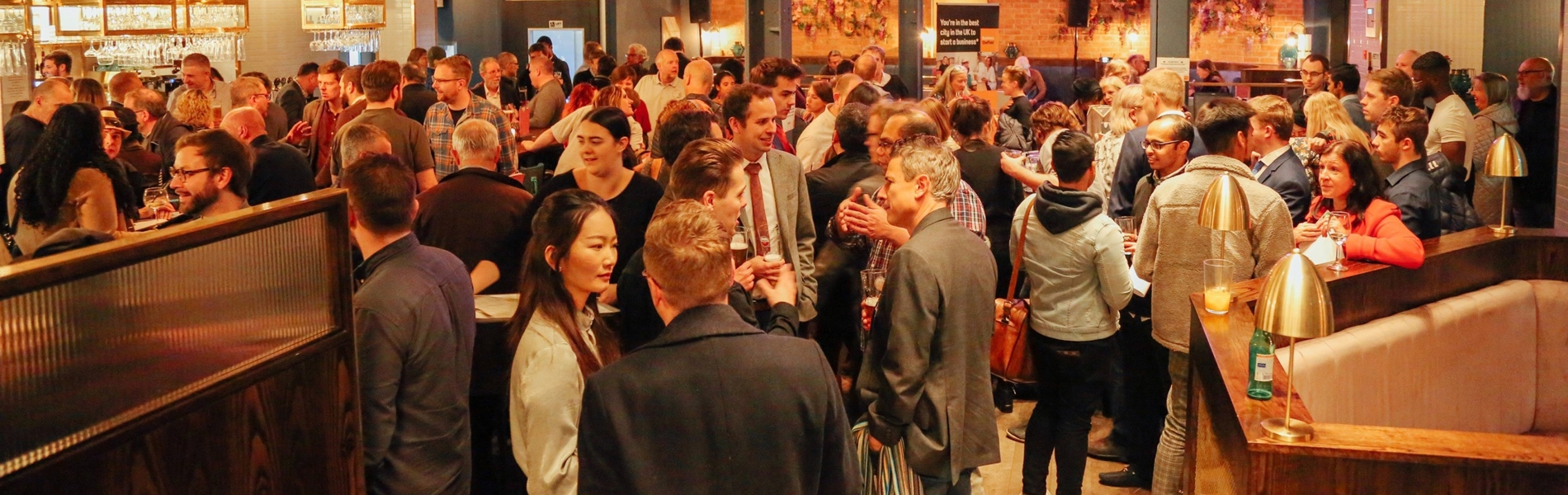 Entrepreneurs mingle at a busy networking event. 
