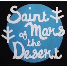 Logo with white handwritten-style text reading ‘Saint of Mars the Desert’ on a blue circular background, with three white tree-like symbols positioned around the text.