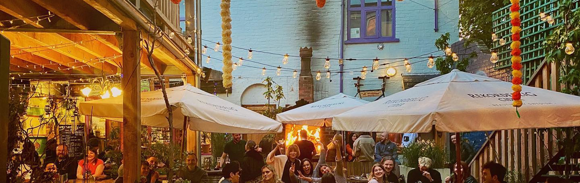 The courtyard at Haggles Coner, filled with people dining.