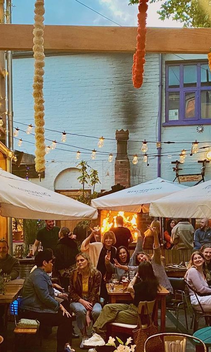 The courtyard at Haggles Coner, filled with people dining.