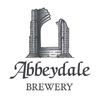 Logo for Abbeydale Brewery featuring an illustration of a stone archway or ruins in gray above the text “Abbeydale” in a stylised serif font, with the word “BREWERY” in smaller capital letters below.